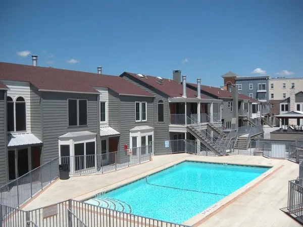 a view of a house with pool and chairs