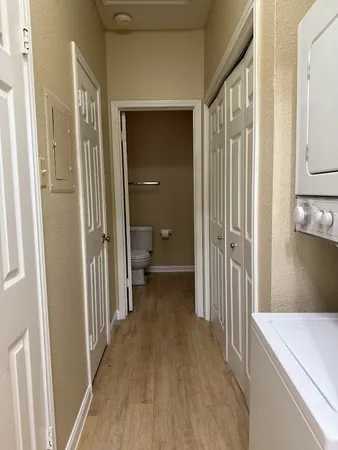 a view of a hallway with a livingroom and a hallway