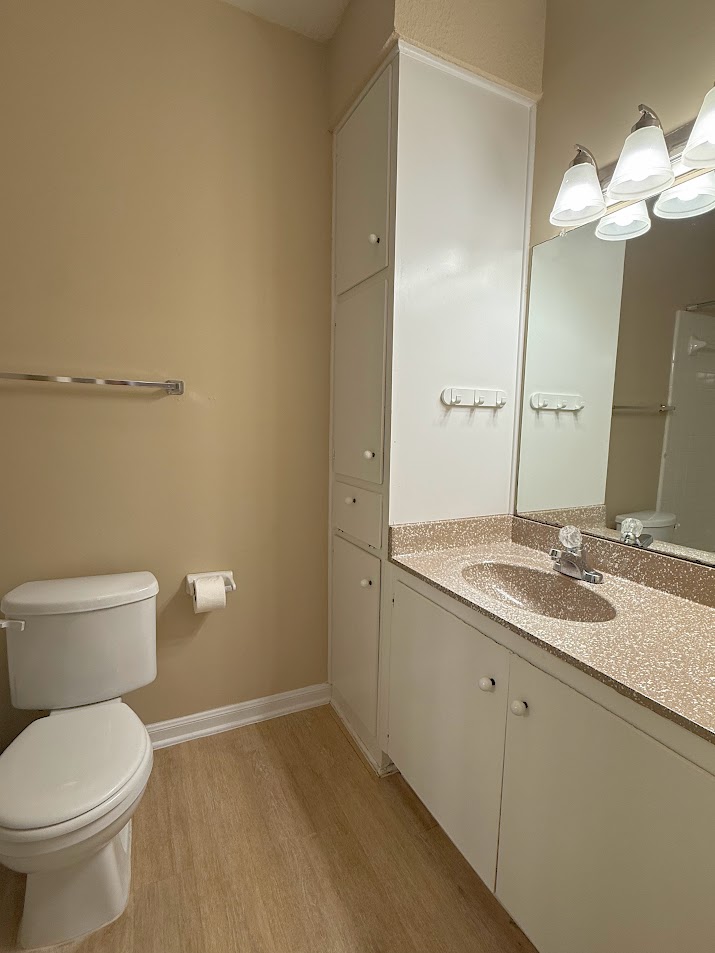 2529 Rio Grande Street, Unit 96 Austin, TX 78705 - Photo 9 of 11 Bathroom featuring toilet, wood finished floors, vanity, and baseboards