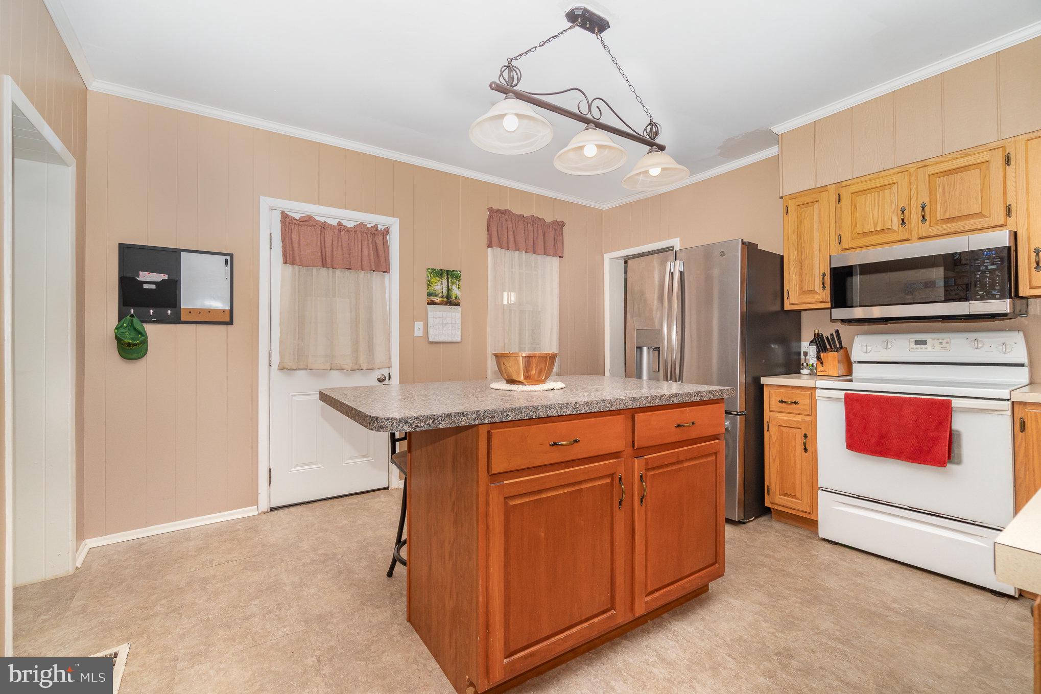 21 West Gramby Street Manheim, PA 17545 - Photo 13 of 36 a kitchen with stainless steel appliances granite countertop a refrigerator and a stove top oven