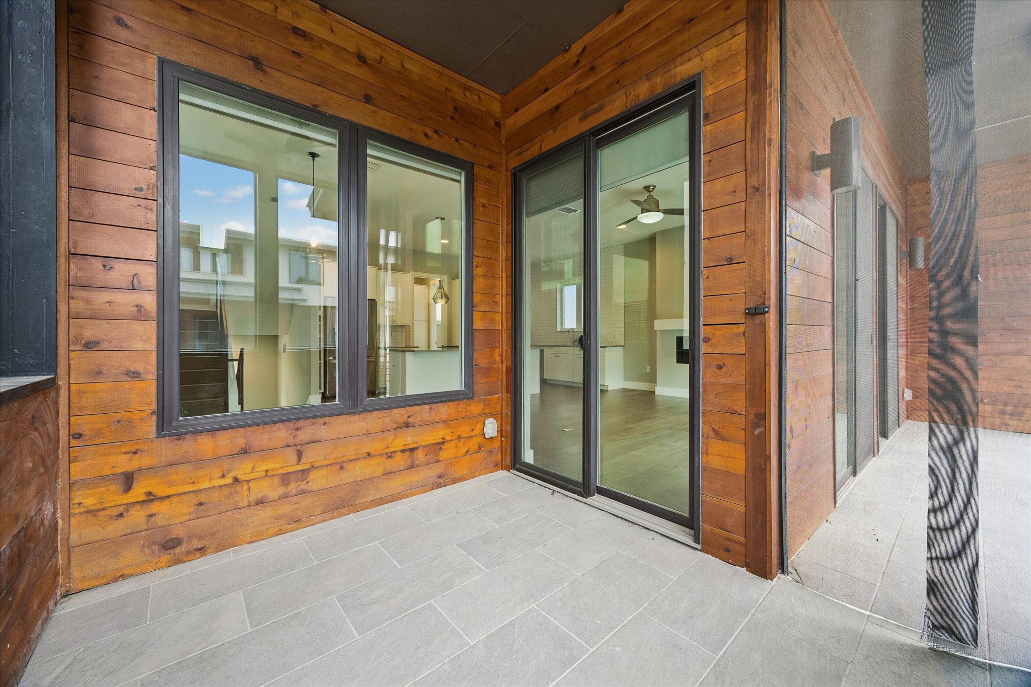 5006 Pecan Springs Road, Unit 6 Austin, TX 78723 - Photo 27 of 30 A private outdoor patio with wood siding and sleek tile flooring provides a serene escape.