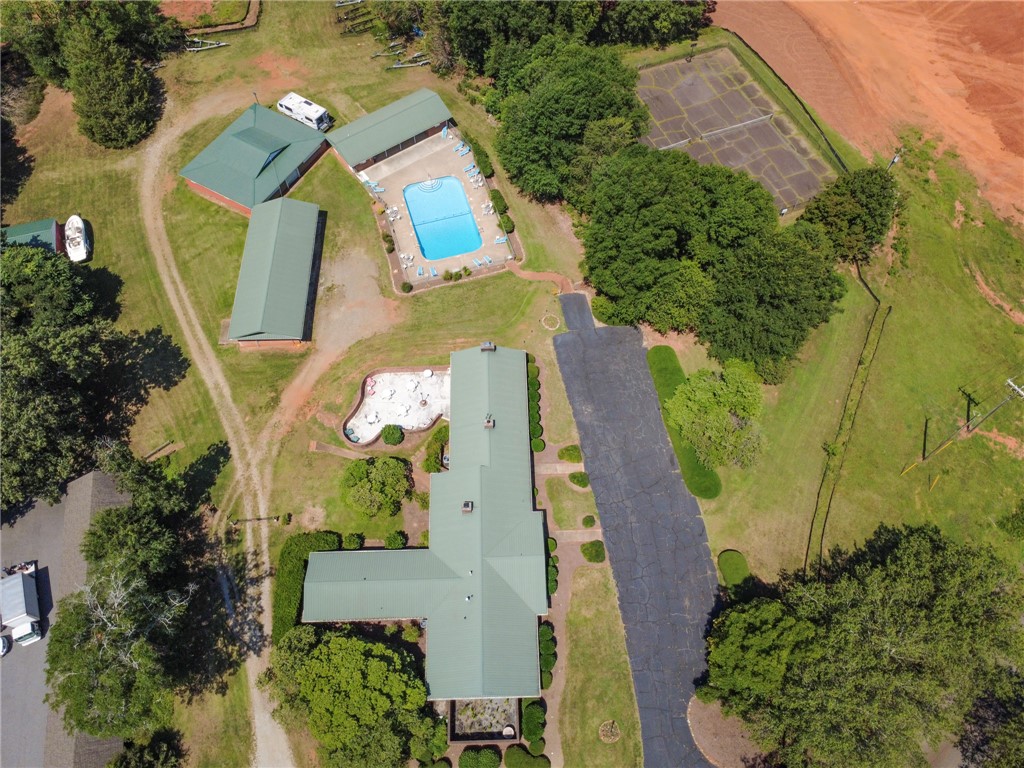 1302 Leeward Road Anderson, SC 29625 - Photo 47 of 50 An aerial perspective reveals a vast estate with recreational amenities, including two swimming pools and a tennis court.