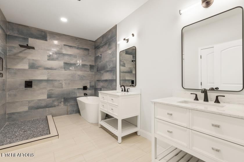 1937 River Poppy Road Mascot, TN 37806 - Photo 21 of 26 a bathroom with a double vanity sink mirror and bathtub