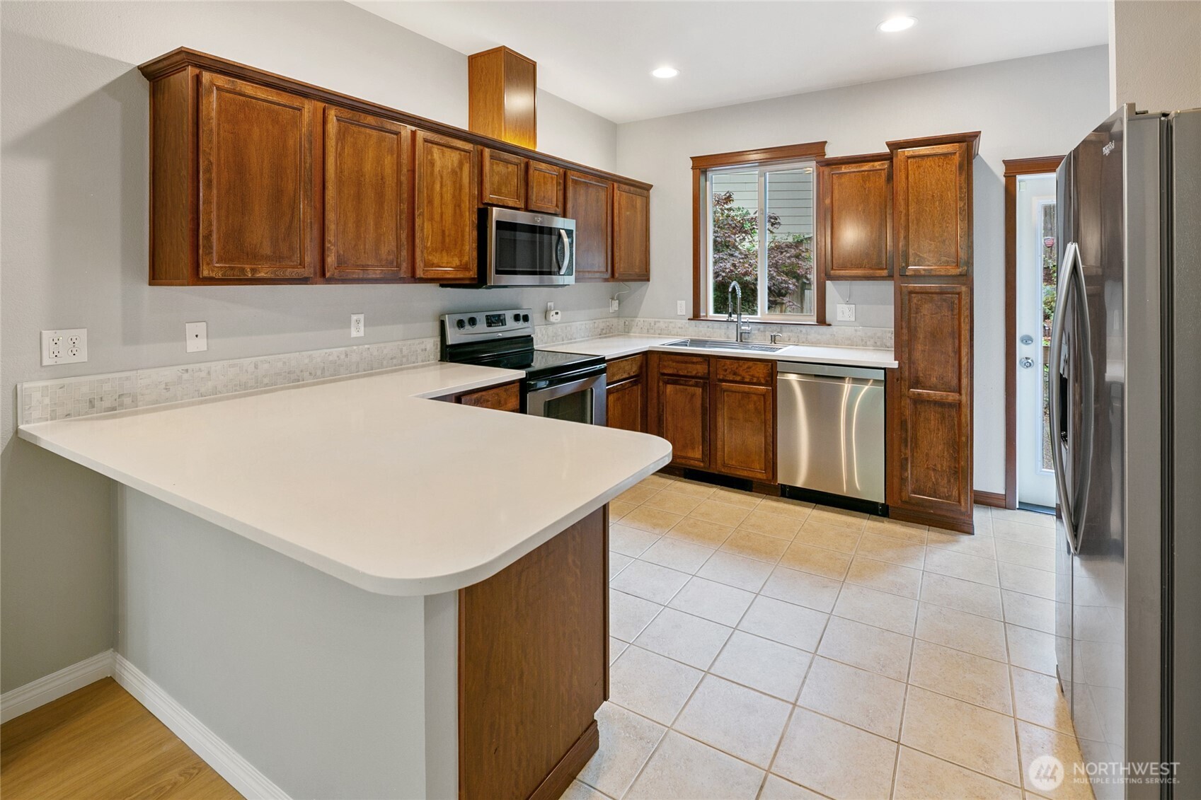 2923 Belmonte Lane Everett, WA 98201 - Photo 12 of 33 a kitchen with stainless steel appliances a refrigerator sink stove microwave and cabinets