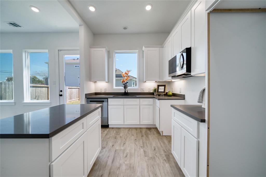8107 Calhoun Road Houston, TX 77033 - Photo 4 of 16 a kitchen with stainless steel appliances granite countertop a sink and cabinets