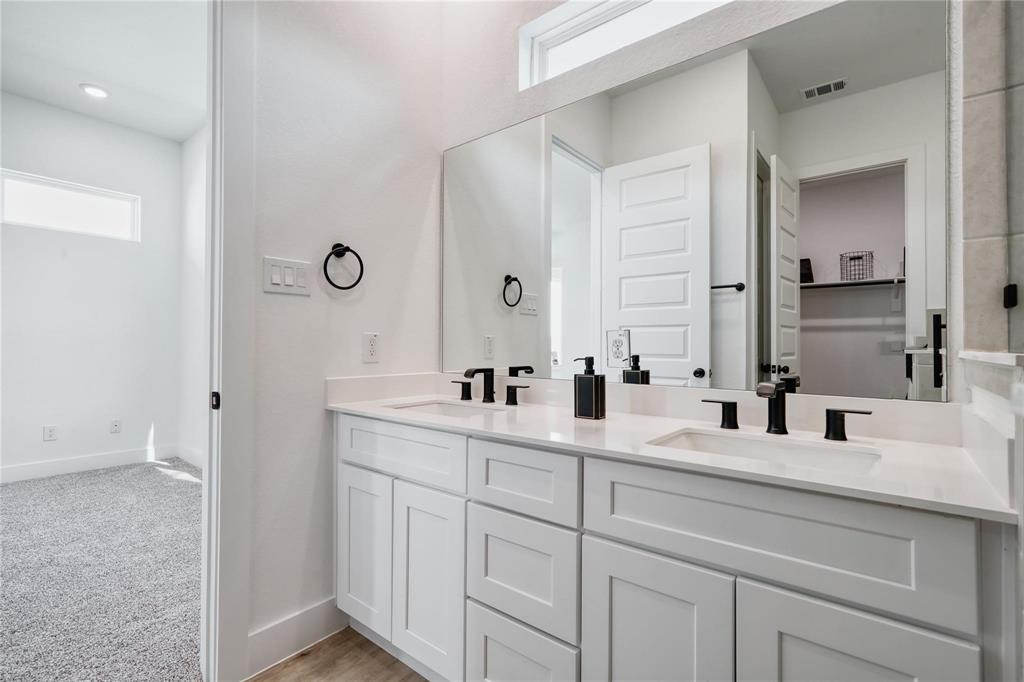 8107 Calhoun Road Houston, TX 77033 - Photo 9 of 16 a bathroom with double sink and a mirror