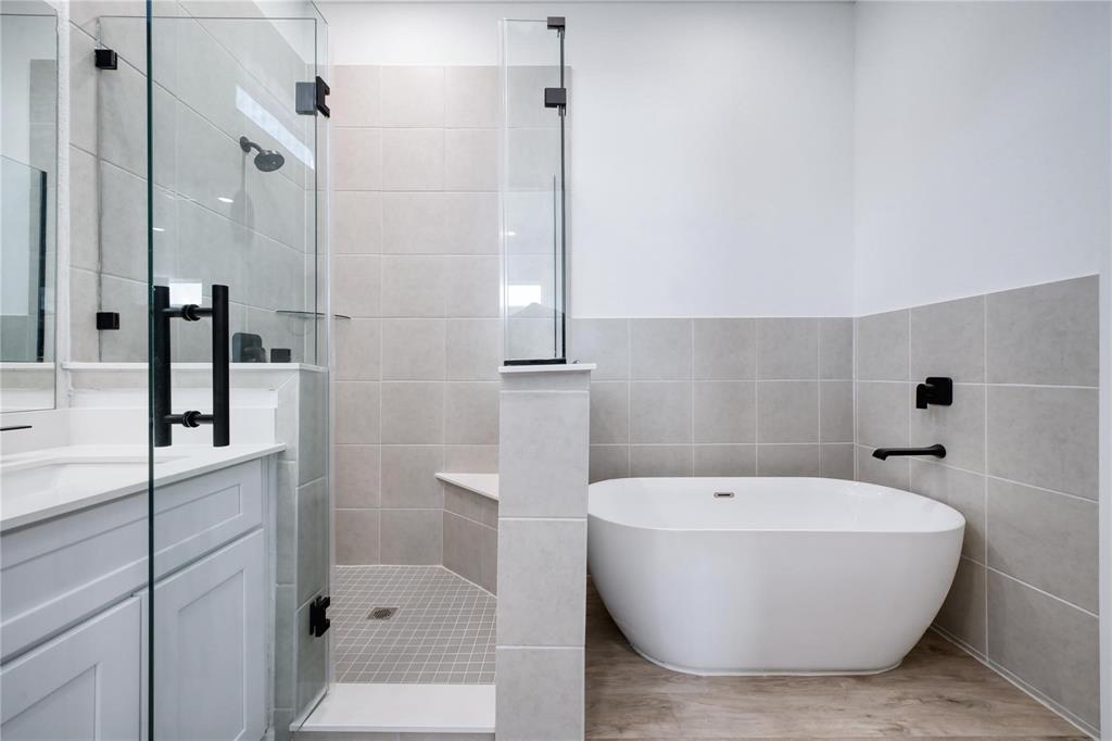8107 Calhoun Road Houston, TX 77033 - Photo 10 of 16 a bathroom with a bathtub and shower