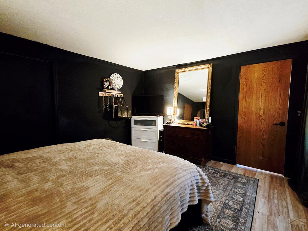 205 3rd Street Swink, CO 81077 - Photo 11 of 26 a bedroom with a bed and a dresser