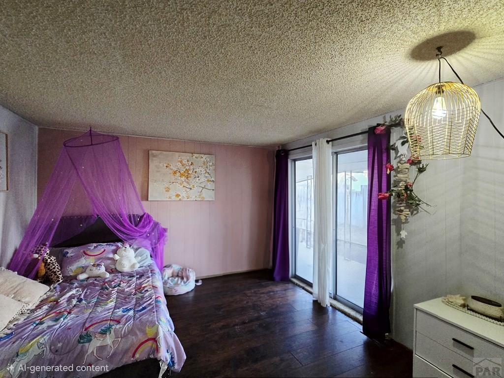 205 3rd Street Swink, CO 81077 - Photo 14 of 26 a bedroom with a bed and a chandelier