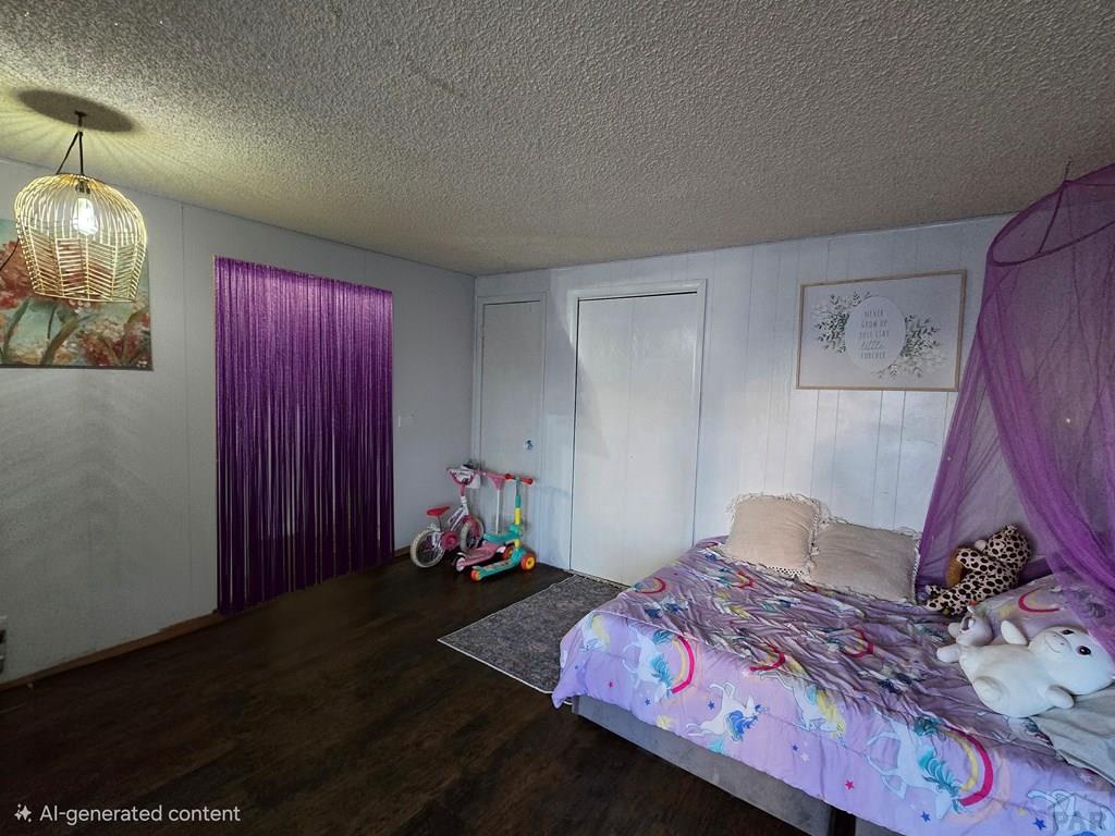 205 3rd Street Swink, CO 81077 - Photo 15 of 26 a bedroom with a bed and a chandelier