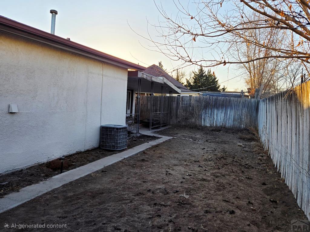 205 3rd Street Swink, CO 81077 - Photo 22 of 26 a view of a backyard with potted plants and wooden fence