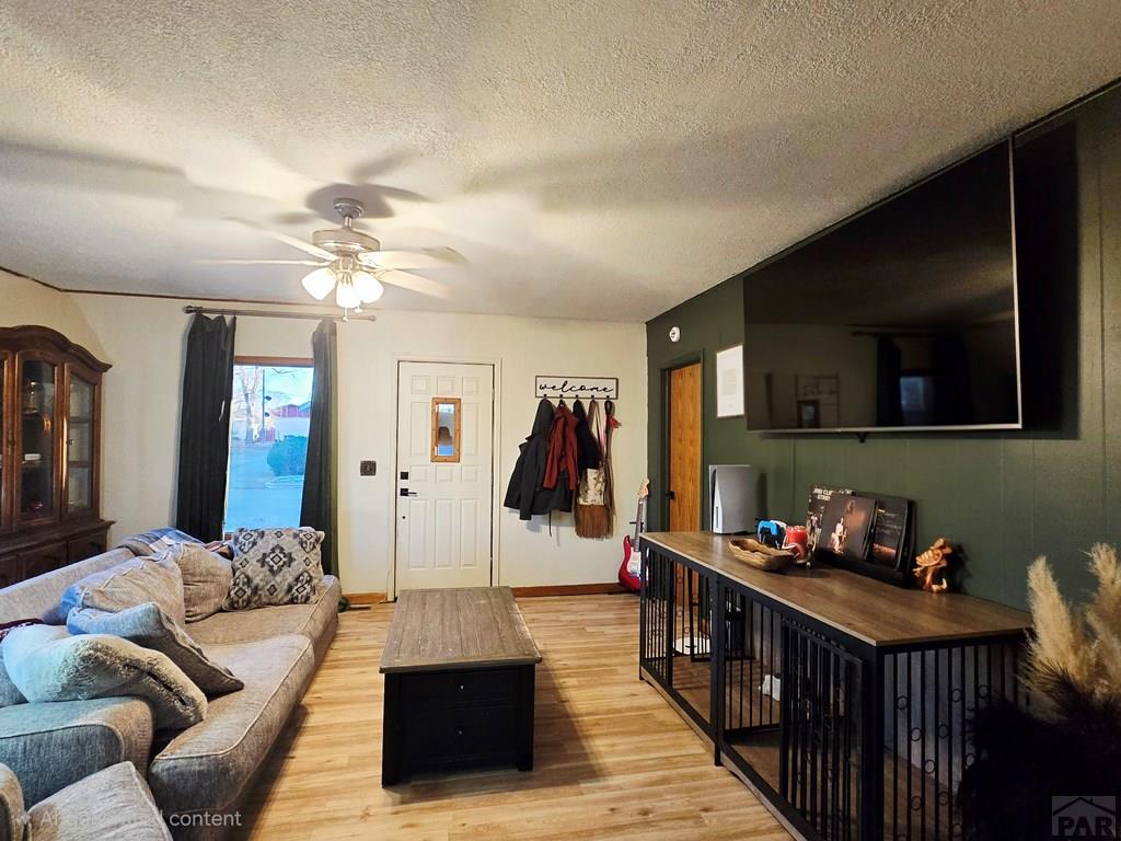 205 3rd Street Swink, CO 81077 - Photo 3 of 26 a living room with furniture and a flat screen tv