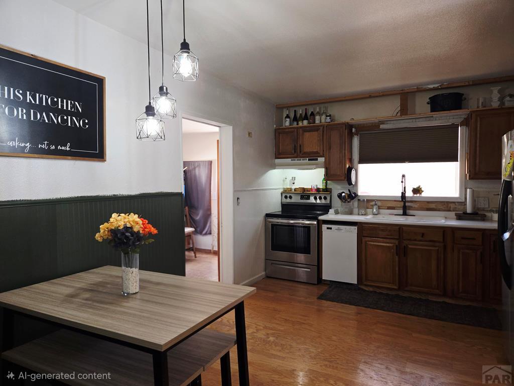 205 3rd Street Swink, CO 81077 - Photo 6 of 26 a kitchen with stainless steel appliances kitchen island granite countertop a table chairs and a refrigerator