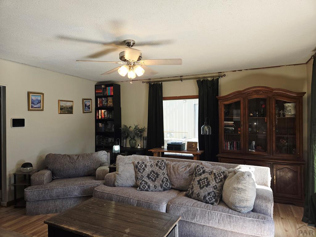 205 3rd Street Swink, CO 81077 - Photo 9 of 26 a living room with furniture and a large window