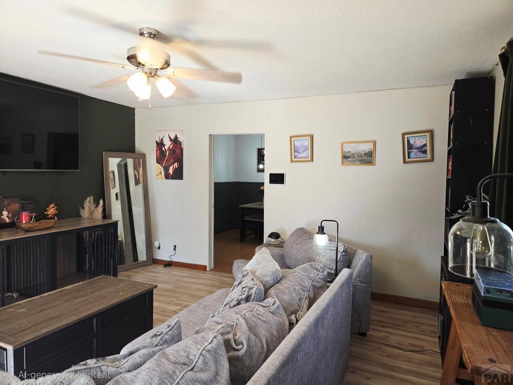 205 3rd Street Swink, CO 81077 - Photo 10 of 26 a living room with furniture and a flat screen tv