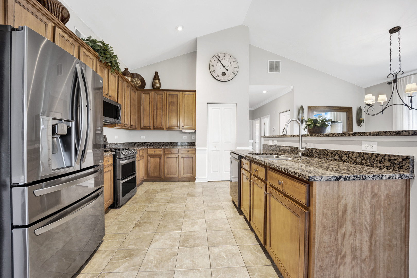 1914 Havenshire Road, Unit 1914 Aurora, IL 60502 - Photo 9 of 31 a kitchen with stainless steel appliances granite countertop a refrigerator a stove and a sink with wooden floor