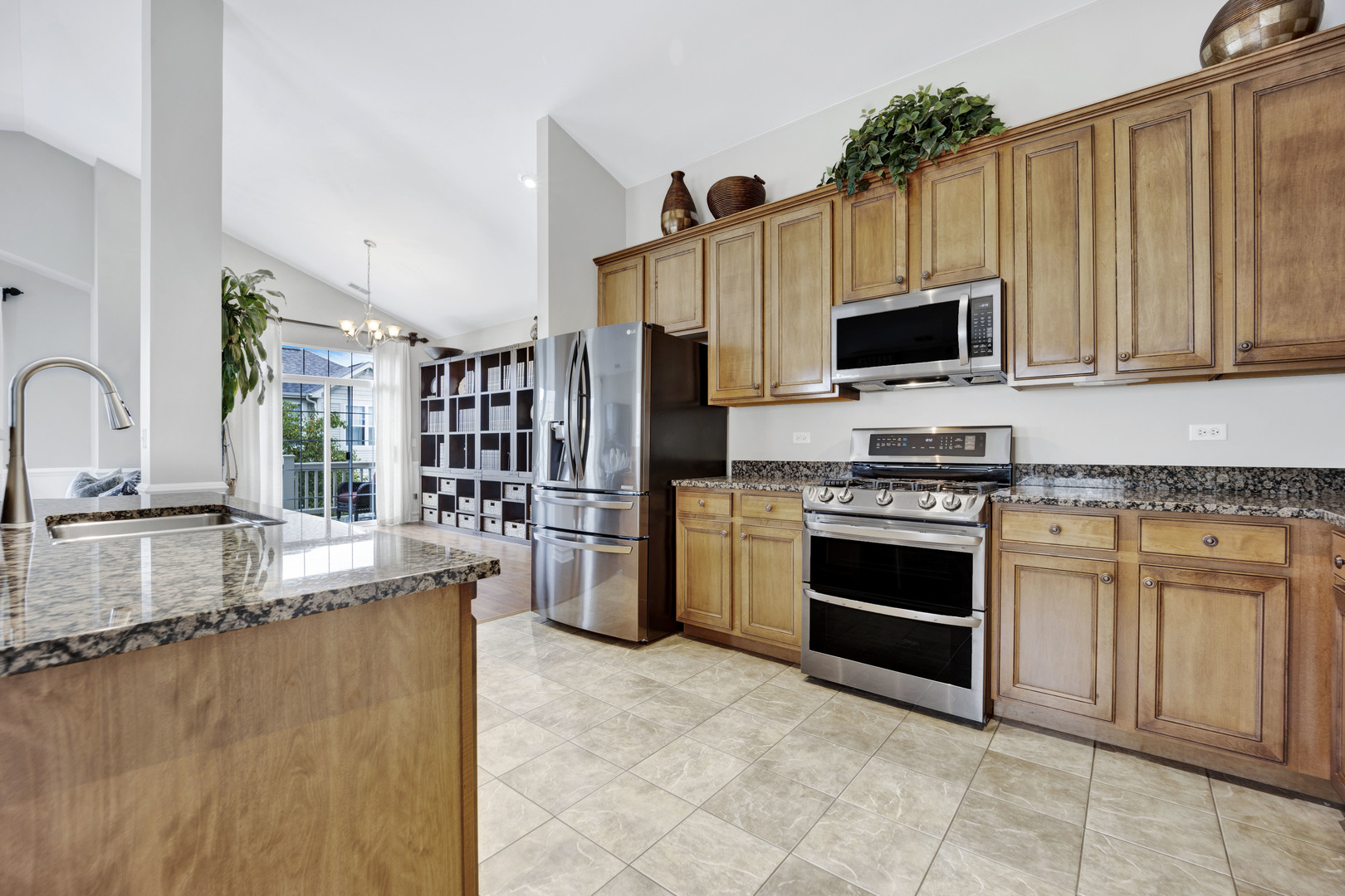 1914 Havenshire Road, Unit 1914 Aurora, IL 60502 - Photo 10 of 31 a kitchen with stainless steel appliances granite countertop a stove a sink and a microwave