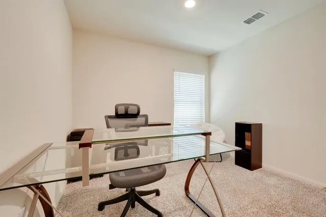 a living room with a table and a chair