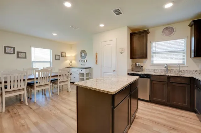 a kitchen with center island table and chairs