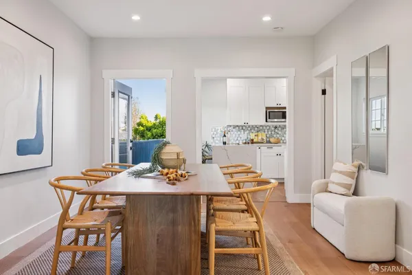 a view of a dining room with furniture and wooden floor