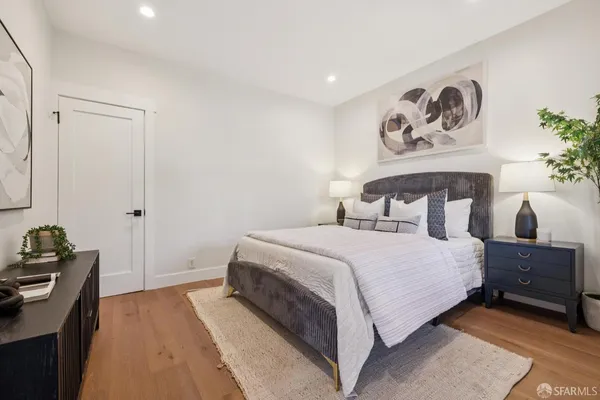 a living room with furniture and painting on the wall