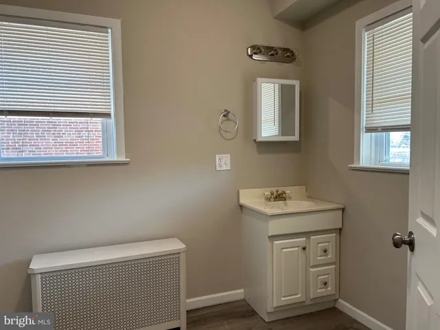 a bathroom with a toilet a sink and a mirror
