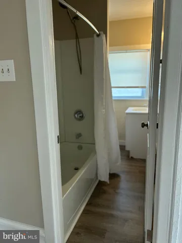 a bathroom with a bathtub and a shower