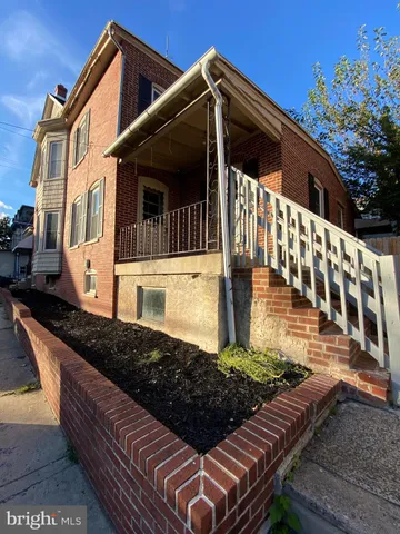 a view of a house with wooden fence