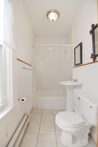 a white toilet sitting next to a bath tub