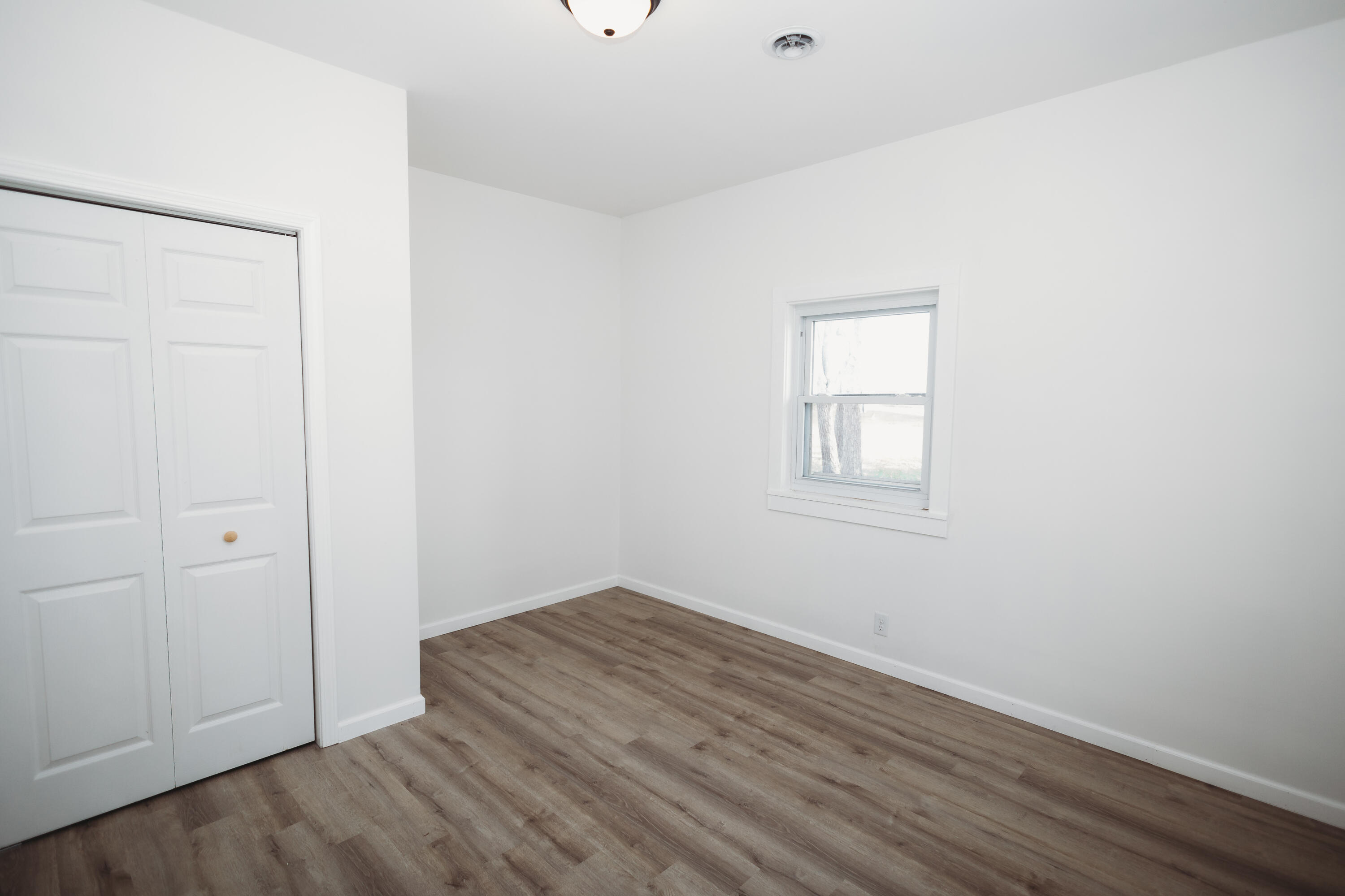 4812 East Bootjack Road Rolling Prairie, IN 46371 - Photo 12 of 13 an empty room with wooden floor and windows