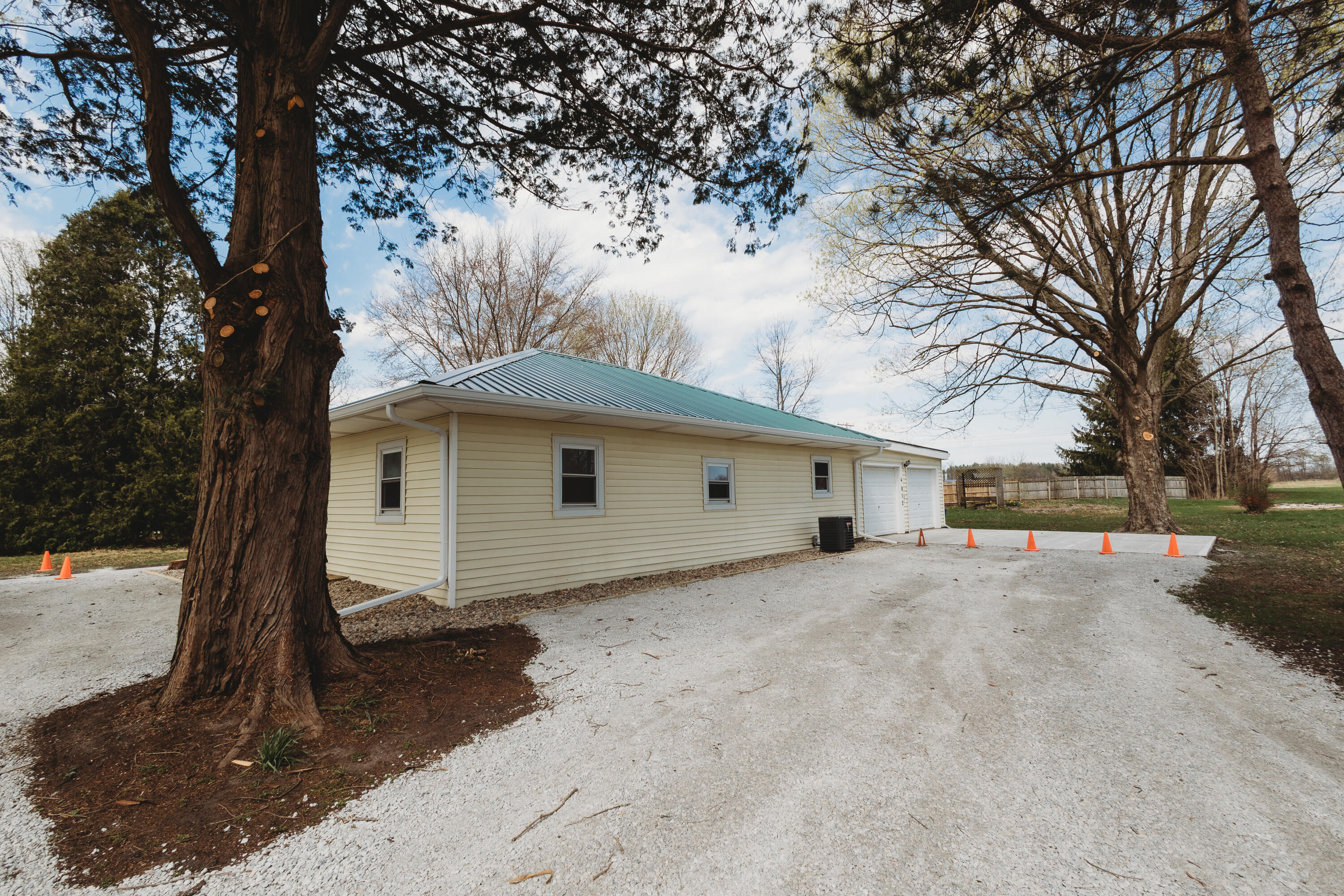 4812 East Bootjack Road Rolling Prairie, IN 46371 - Photo 2 of 13 a white house that has a tree in front of it
