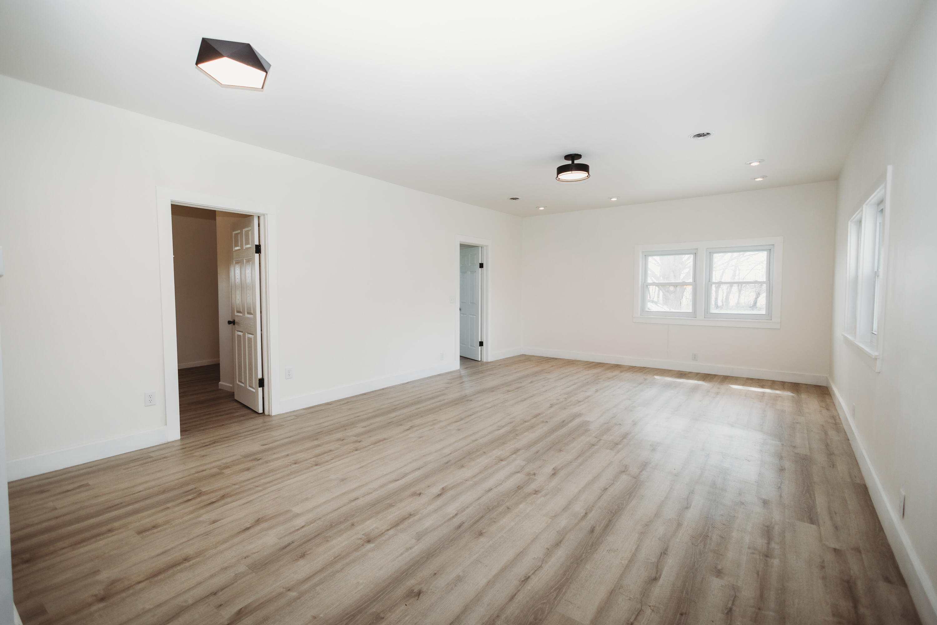 4812 East Bootjack Road Rolling Prairie, IN 46371 - Photo 4 of 13 an empty room with wooden floor and windows