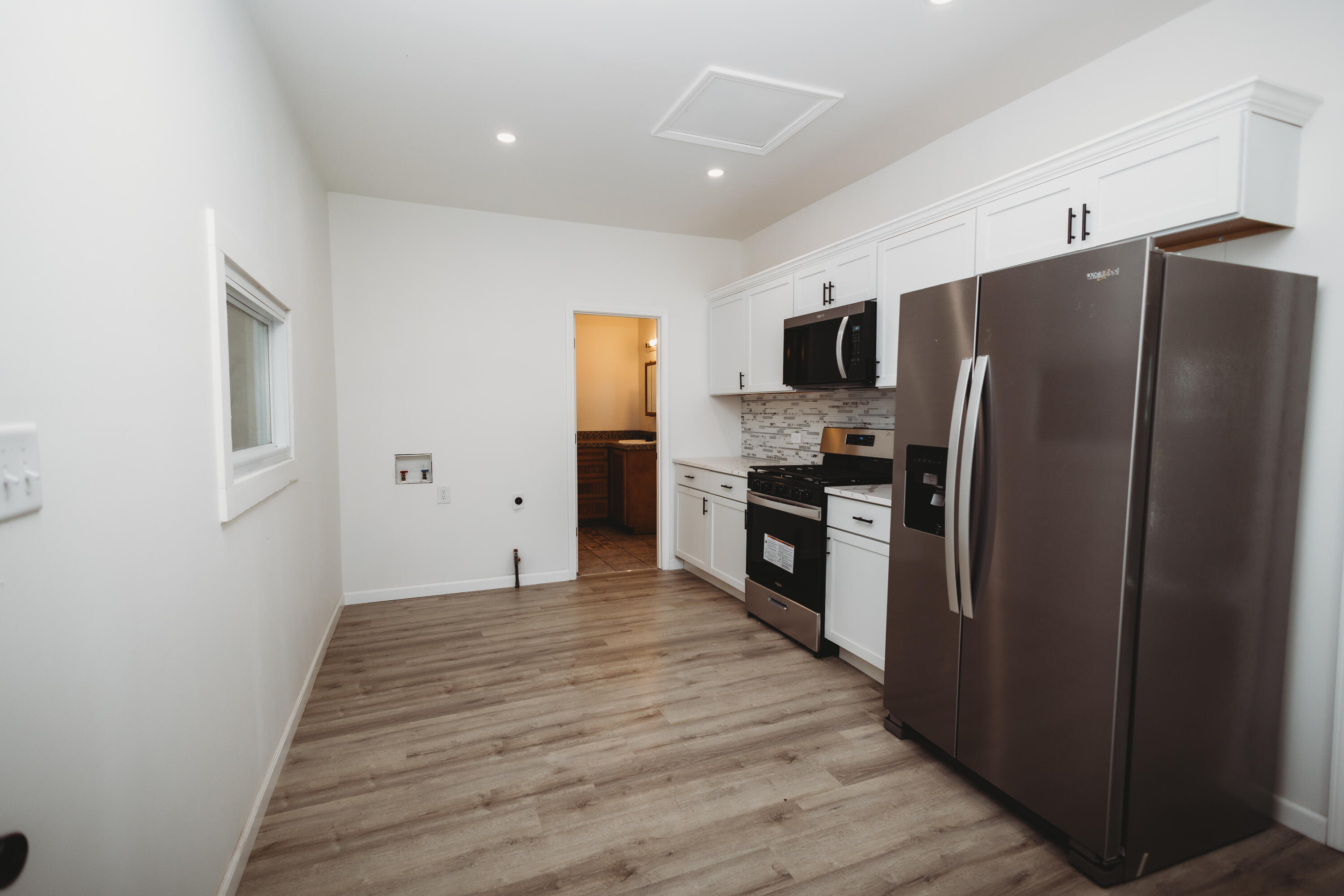 4812 East Bootjack Road Rolling Prairie, IN 46371 - Photo 5 of 13 a kitchen with stainless steel appliances a refrigerator and a stove top oven