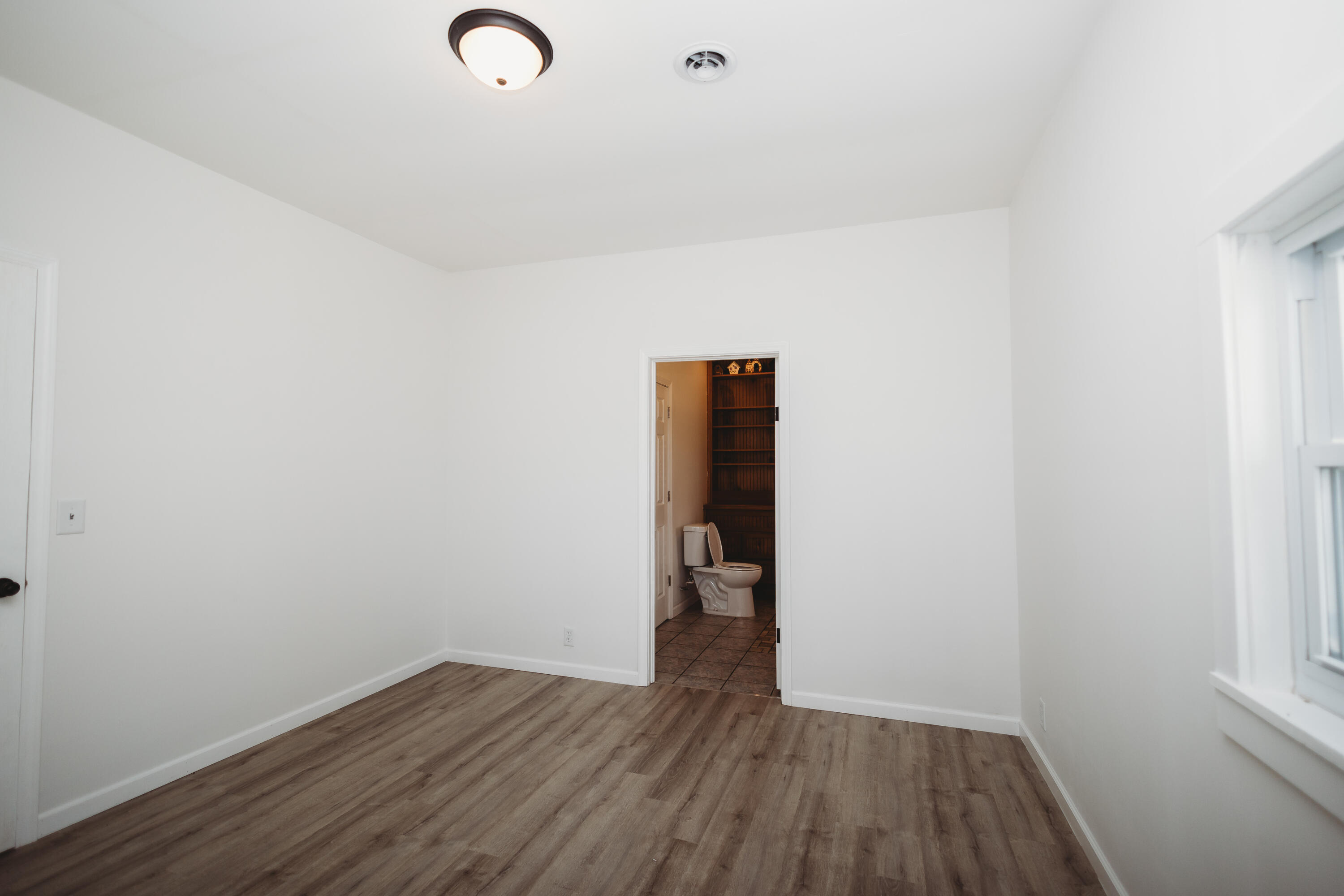 4812 East Bootjack Road Rolling Prairie, IN 46371 - Photo 7 of 13 a view of an empty room with wooden floor and closet