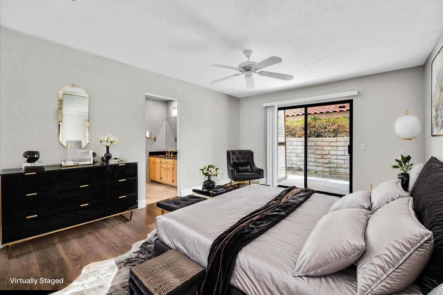 45 Lincoln Place Rancho Mirage, CA 92270 - Photo 23 of 59 a bedroom with a bed and a chandelier fan
