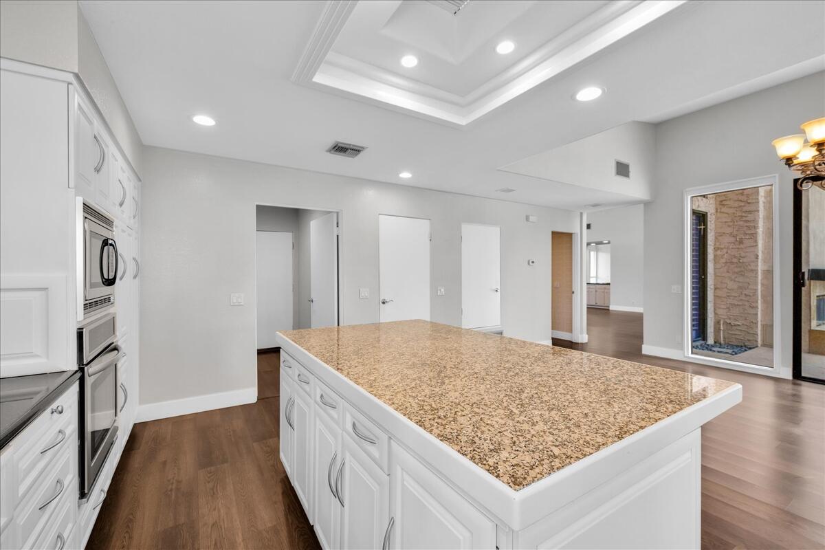 45 Lincoln Place Rancho Mirage, CA 92270 - Photo 9 of 59 a bathroom with a granite countertop sink and a refrigerator