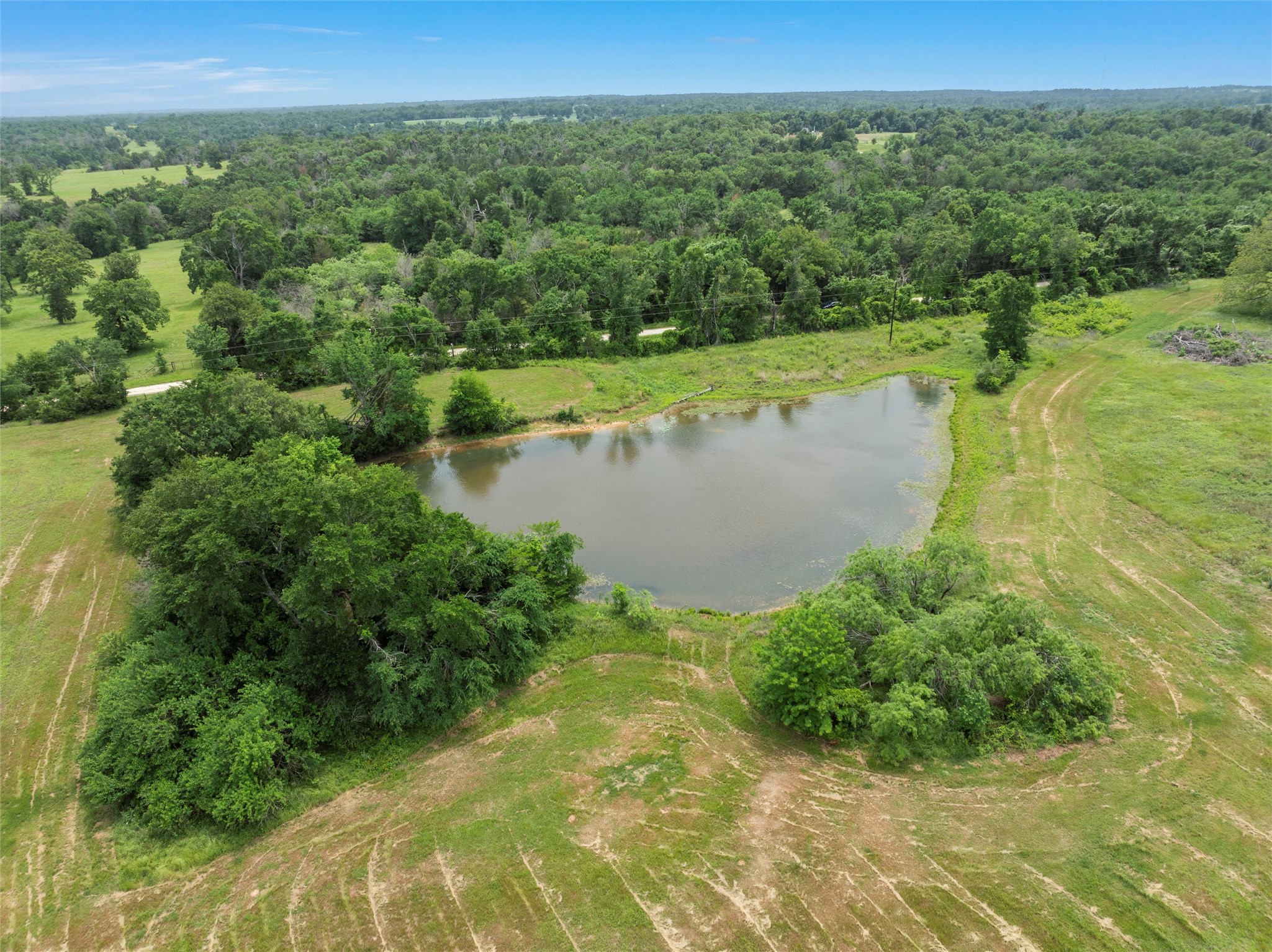 707 Lcr 707 Kosse, TX 76653 - Photo 3 of 15 a view of a lake with a yard and mountain view