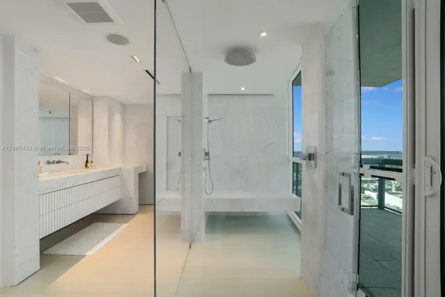 a bathroom with a tub sink shower and mirror