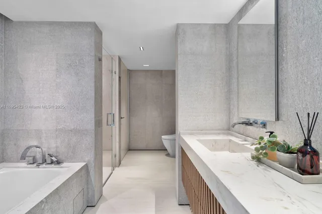 a bathroom with a tub sink and mirror