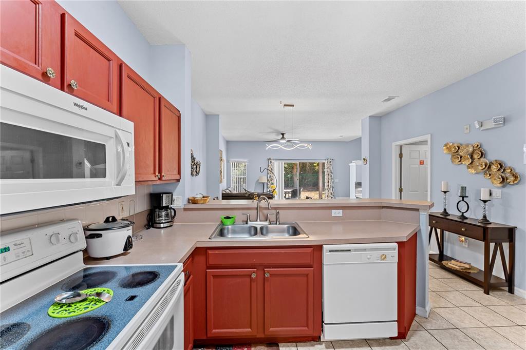 1017 Park Ridge Circle Kissimmee, FL 34746 - Photo 13 of 52 a kitchen with stainless steel appliances granite countertop a sink and a stove