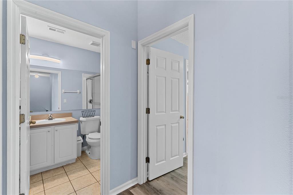 1017 Park Ridge Circle Kissimmee, FL 34746 - Photo 16 of 52 a view of a bathroom with a sink and mirror