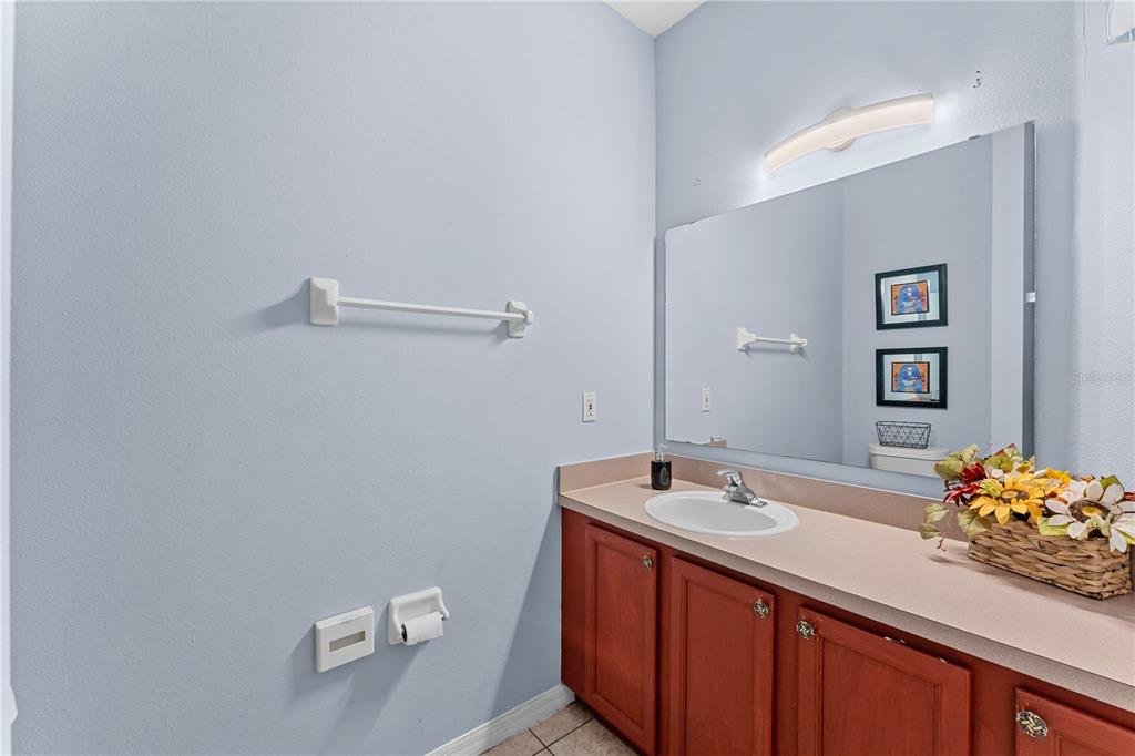 1017 Park Ridge Circle Kissimmee, FL 34746 - Photo 19 of 52 a bathroom with a sink and a mirror