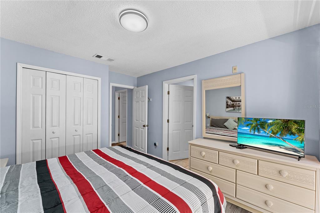 1017 Park Ridge Circle Kissimmee, FL 34746 - Photo 22 of 52 a bedroom with a bed and a potted plant