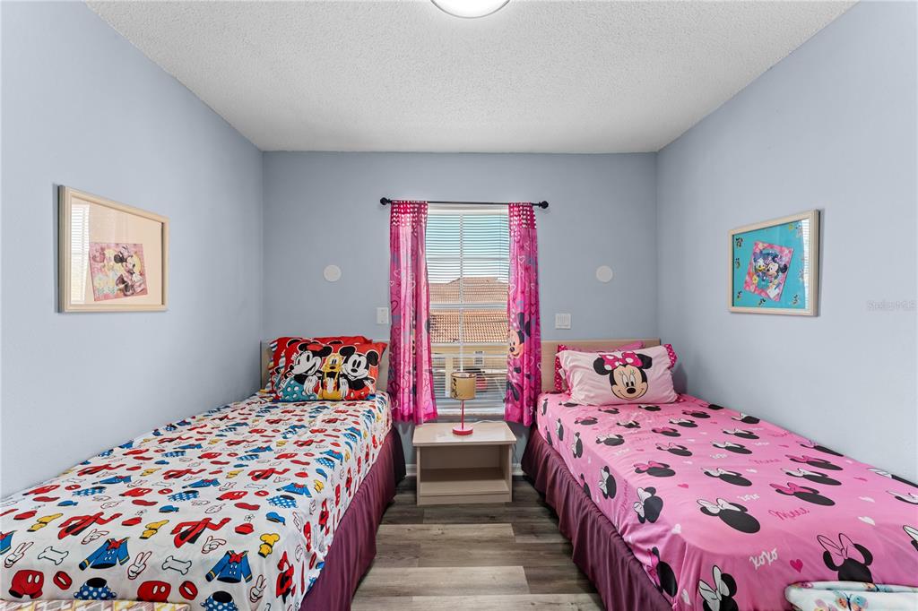 1017 Park Ridge Circle Kissimmee, FL 34746 - Photo 24 of 52 a bedroom with two beds and a dresser next to a window