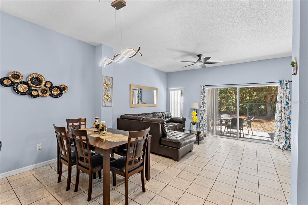1017 Park Ridge Circle Kissimmee, FL 34746 - Photo 3 of 52 a view of a livingroom and a dining room with furniture wooden floor and a chandelier