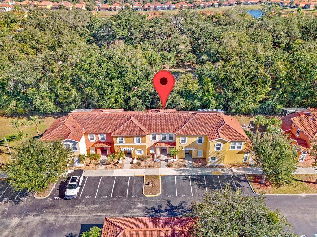 1017 Park Ridge Circle Kissimmee, FL 34746 - Photo 33 of 52 an aerial view of a house with swimming pool and red chairs