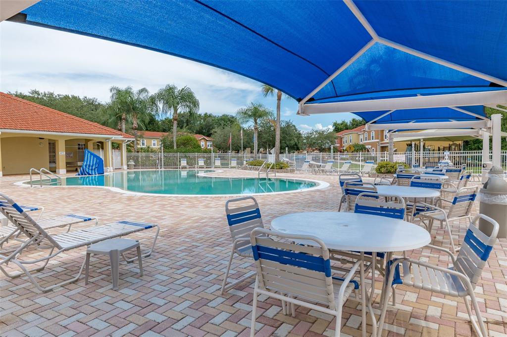 1017 Park Ridge Circle Kissimmee, FL 34746 - Photo 41 of 52 a view of a patio with a table chairs and a backyard
