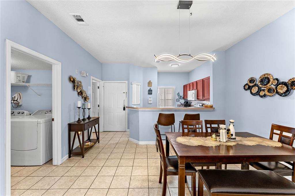 1017 Park Ridge Circle Kissimmee, FL 34746 - Photo 5 of 52 a view of a dining room with furniture and a kitchen