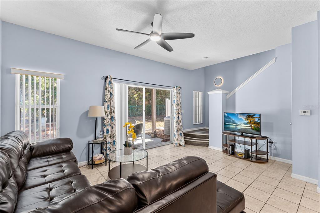1017 Park Ridge Circle Kissimmee, FL 34746 - Photo 6 of 52 a living room with furniture and a flat screen tv