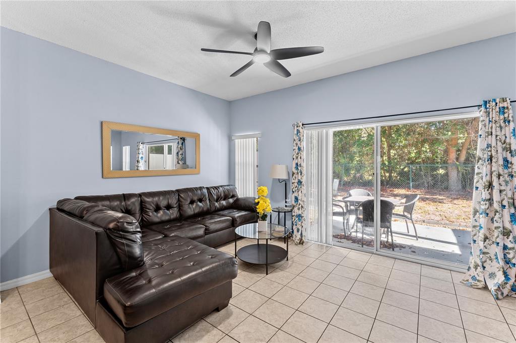 1017 Park Ridge Circle Kissimmee, FL 34746 - Photo 9 of 52 a living room with furniture and a large window